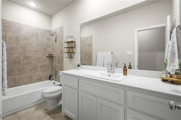 a bathroom with a double vanity sink toilet and shower