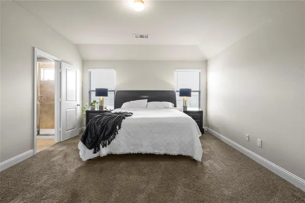 a bedroom with a bed and window