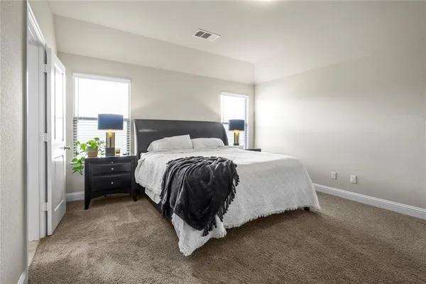 a bedroom with a bed and window