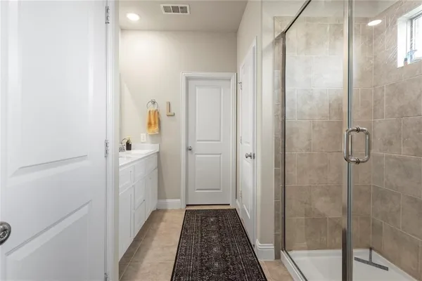 a bathroom with a shower and a sink