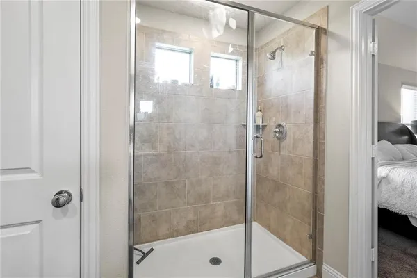 a bathroom with a glass shower door