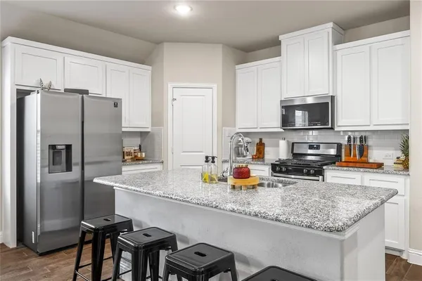 a kitchen with stainless steel appliances and a counter space