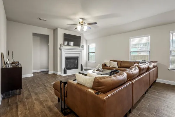 a living room with furniture a fireplace and a flat screen tv