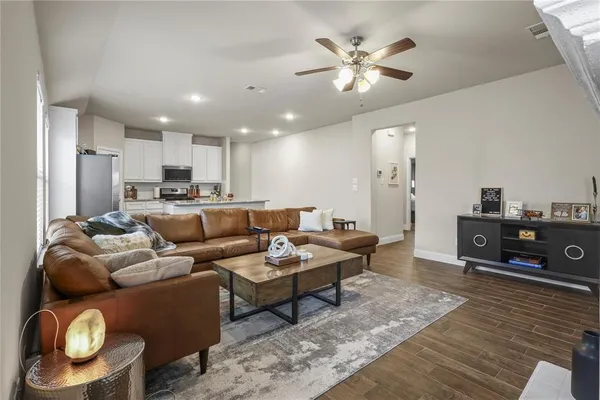 a living room with furniture and wooden floor