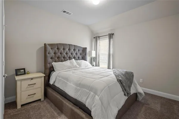 a bedroom with a bed and window