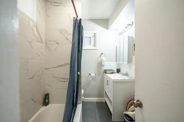 a bathroom with a sink a window and tub