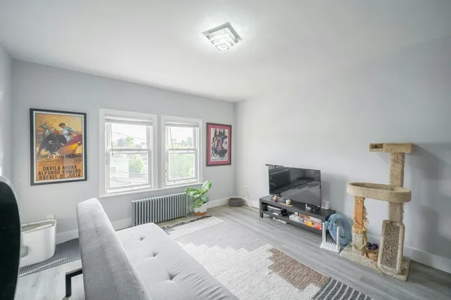 a bedroom with furniture and a flat screen tv