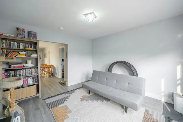 a living room with furniture and a book shelf