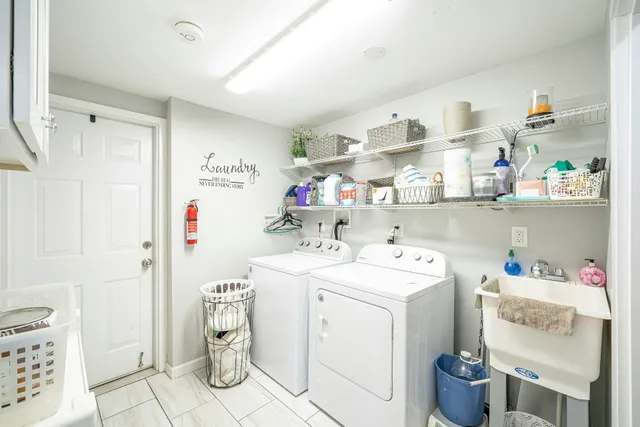 a utility room with cabinets dryer and washer