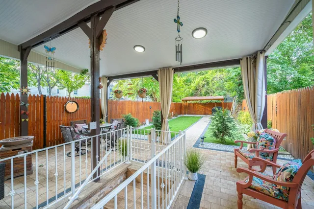 a view of a chairs and table in the balcony