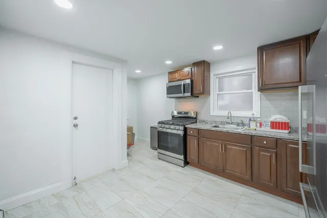 a kitchen with a sink cabinets and stainless steel appliances