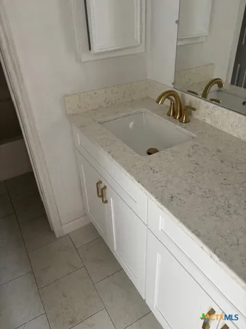 a bathroom with a sink and a mirror