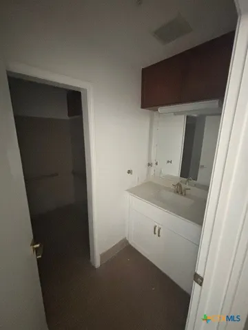 an empty room with a empty space and windows