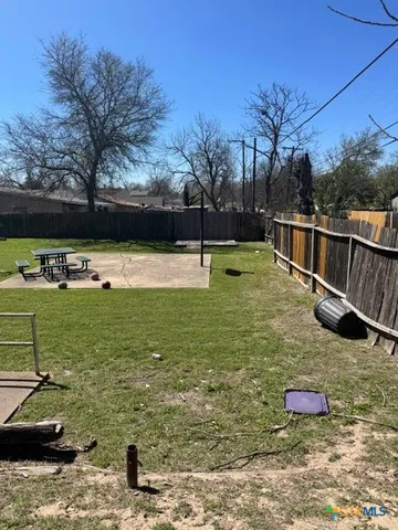 a view of a yard with an outdoor seating