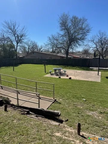 a view of a park with large trees