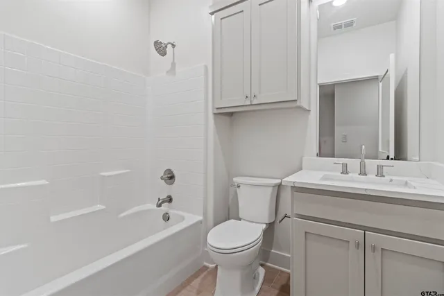 a bathroom with a toilet sink and bathtub