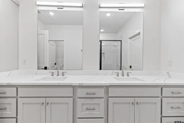a bathroom with a sink vanity and a mirror