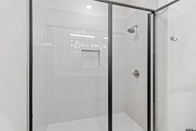 a bathroom with a glass shower door