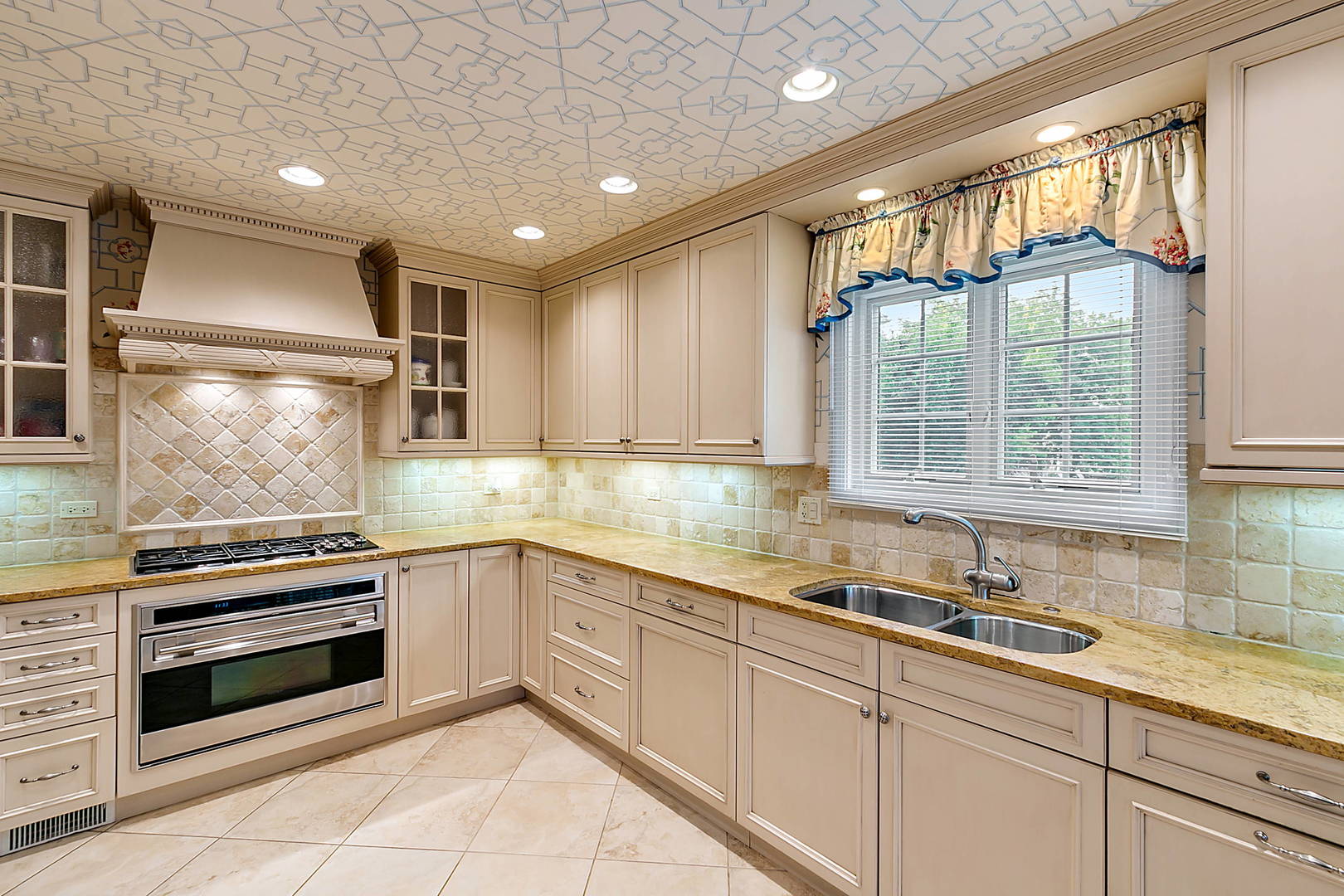 2552 Indian Ridge Court Glenview, IL 60026 - Photo 15 of 45 a kitchen with granite countertop white cabinets and white appliances