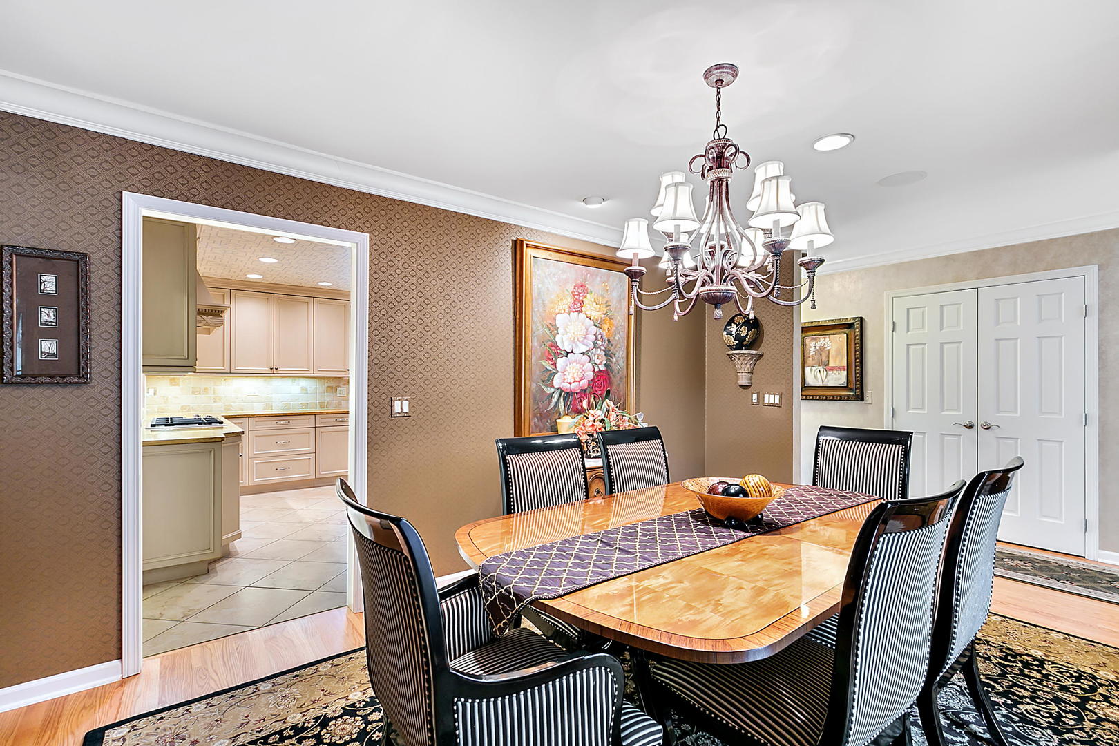2552 Indian Ridge Court Glenview, IL 60026 - Photo 9 of 45 a view of a dining room with furniture a chandelier and wooden floor