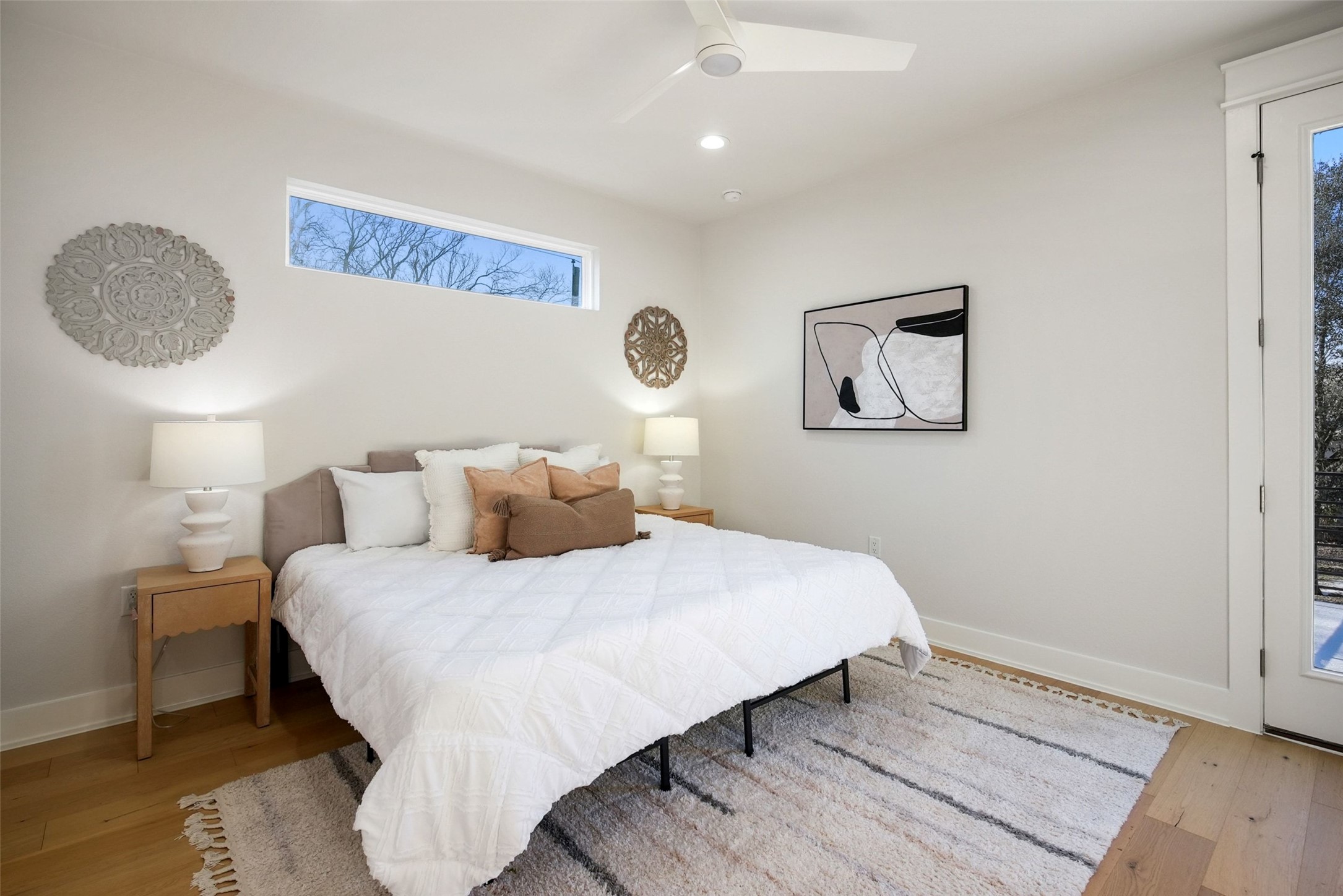 5109 Stone Gate Drive, Unit 2 Austin, TX 78721 - Photo 16 of 36 Bright bedroom featuring wood-finish flooring, a white ceiling fan, and recessed lighting