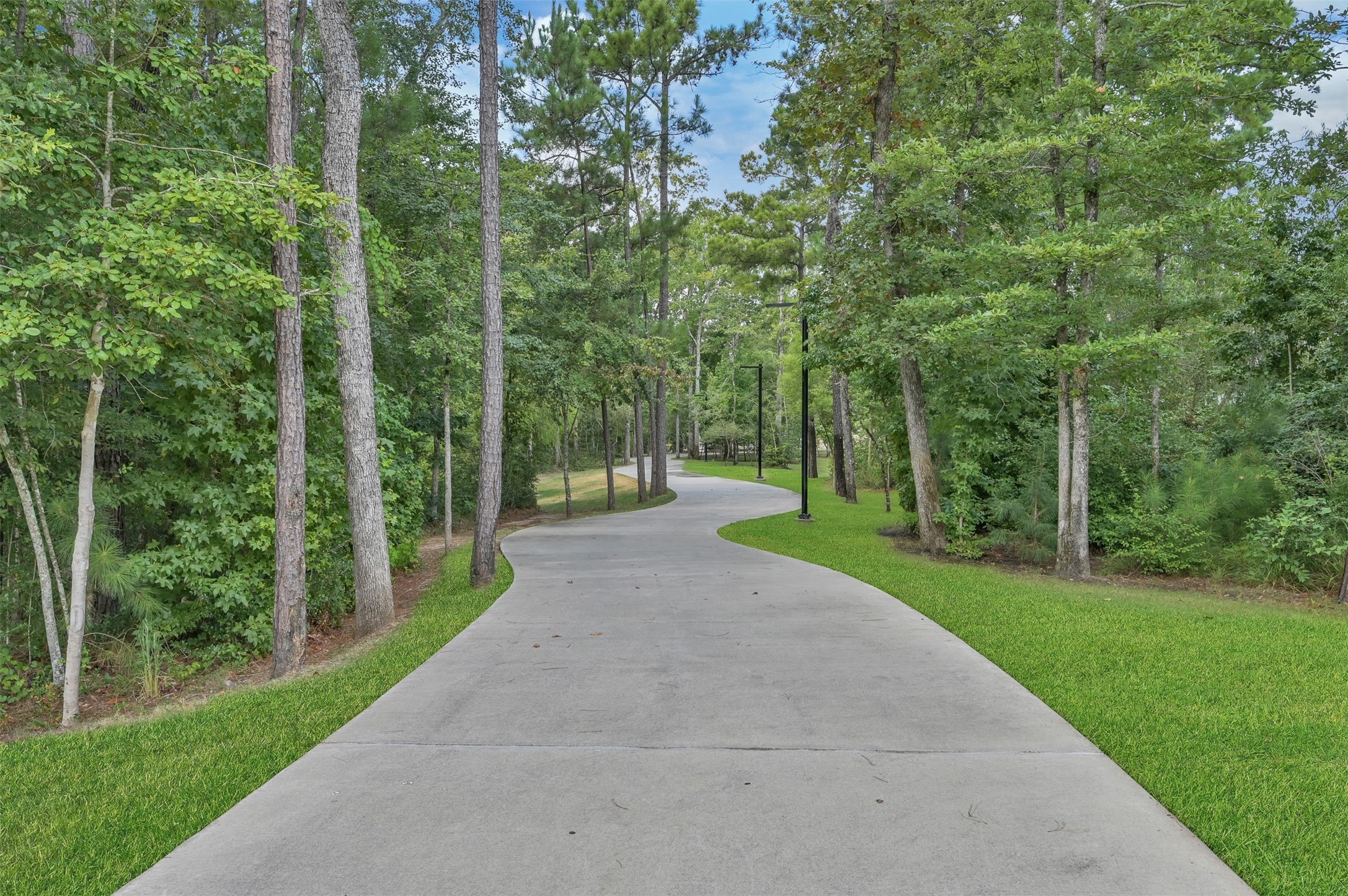 111 Yellow Perch Way Conroe, TX 77318 - Photo 30 of 35 One of many scenic trails throughout The Woodlands Hills, offering miles of hiking and biking paths, including both wooded nature trails and paved pathways for residents to enjoy.