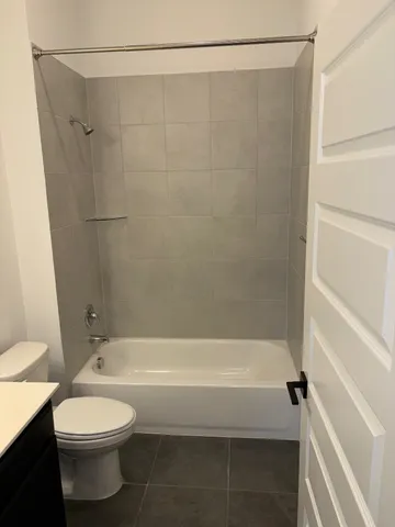 a bathroom with a toilet and a shower