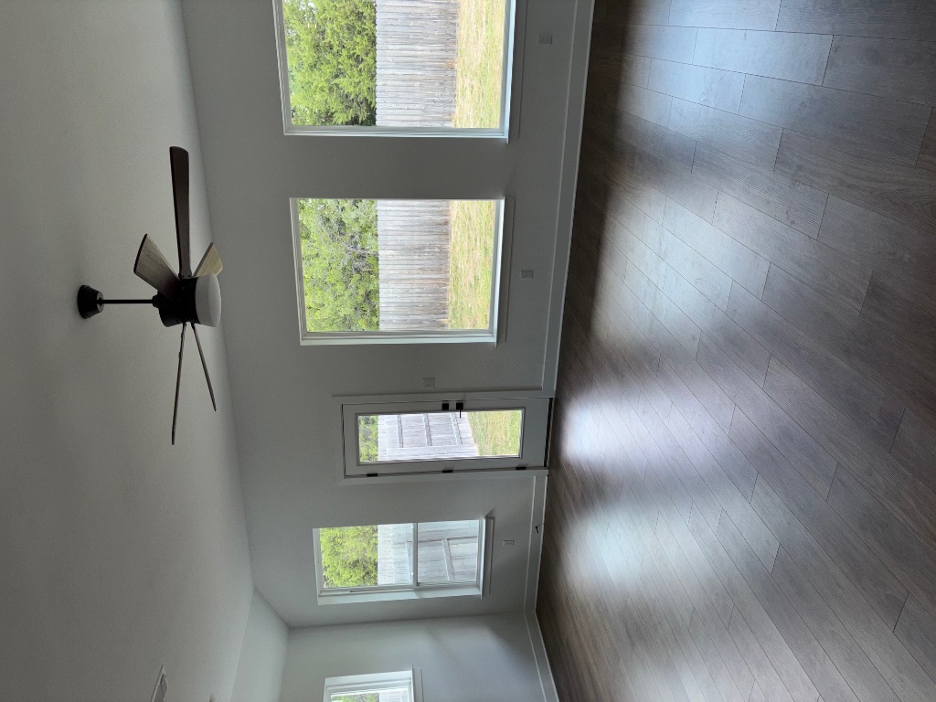 2128 Little Snake Way Georgetown, TX 78633 - Photo 17 of 32 a view of an empty room with wooden floor and a window