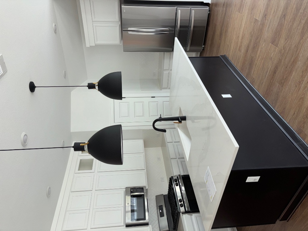 2128 Little Snake Way Georgetown, TX 78633 - Photo 19 of 32 a kitchen with stainless steel appliances a sink a stove a refrigerator and cabinets