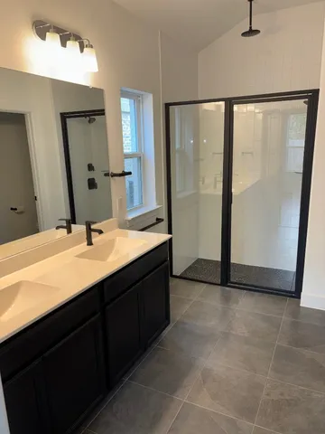 a bathroom with a double vanity sink and mirror