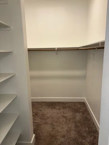 a white toilet sitting next to a white wall