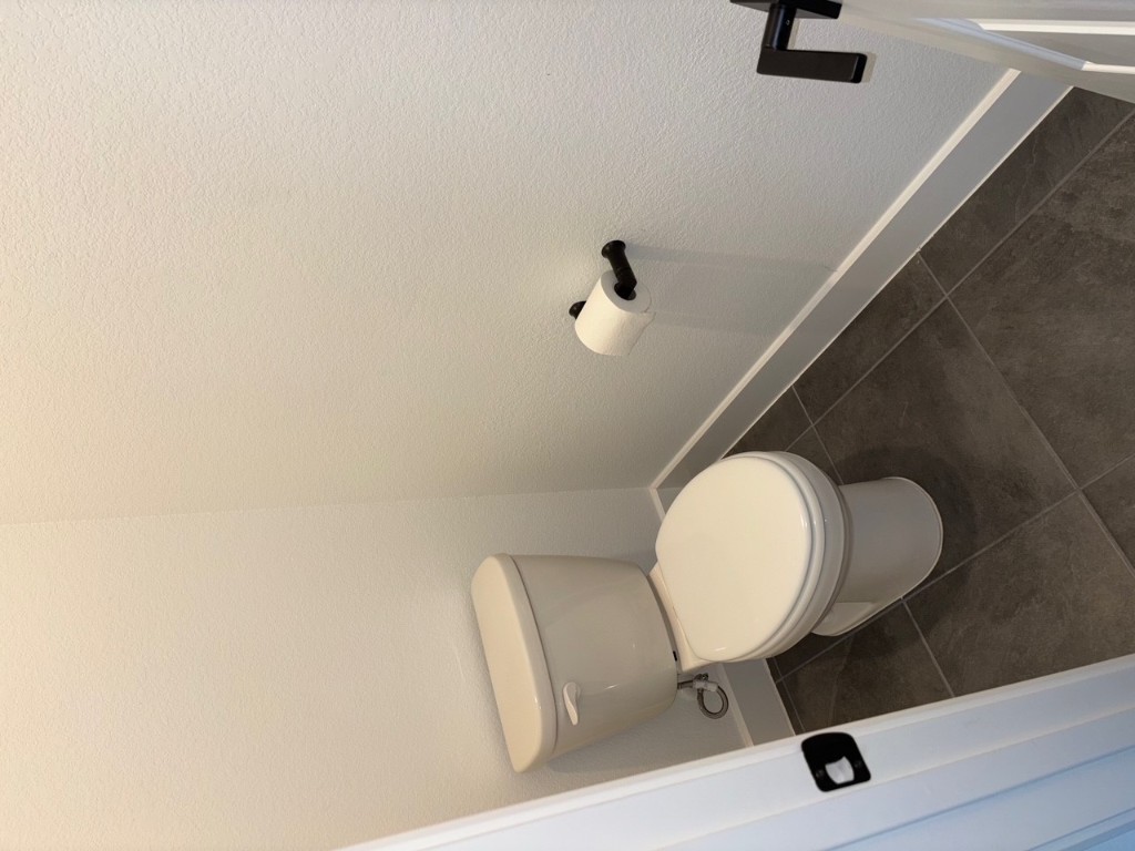 2128 Little Snake Way Georgetown, TX 78633 - Photo 26 of 32 a white toilet sitting next to a white wall