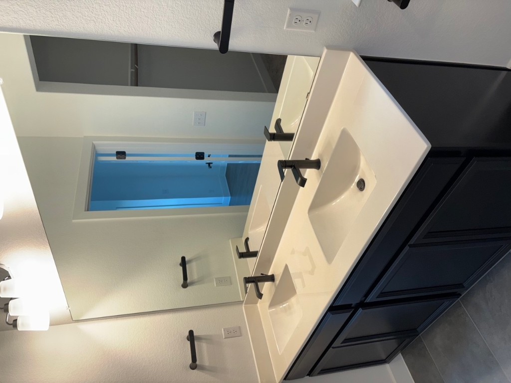 2128 Little Snake Way Georgetown, TX 78633 - Photo 27 of 32 a bathroom with a sink and a mirror