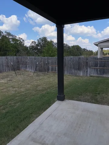 a view of outdoor space with wooden fence
