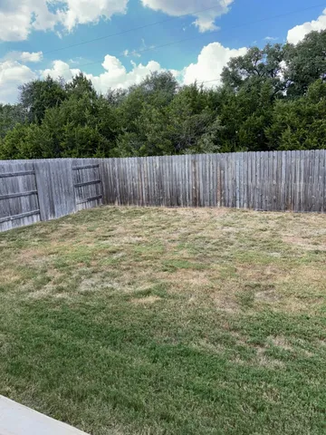 a view of a backyard of the house