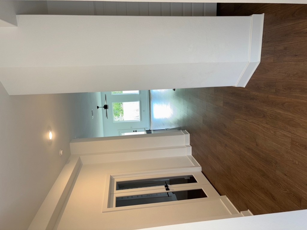 2128 Little Snake Way Georgetown, TX 78633 - Photo 4 of 32 a view of a hallway to an empty room with wooden floor and windows