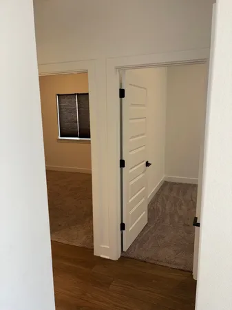 a view of a hallway with wooden floor