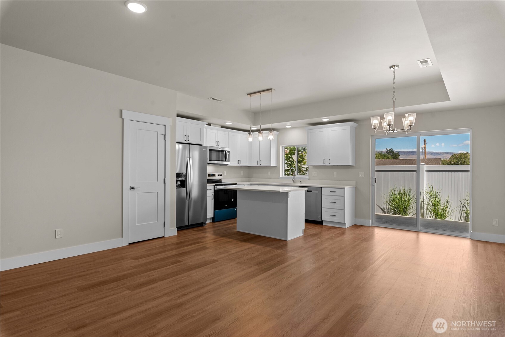 1030 Finch Lane, Unit A3 Wenatchee, WA 98801 - Photo 6 of 24 a kitchen with stainless steel appliances refrigerator wooden floor and window
