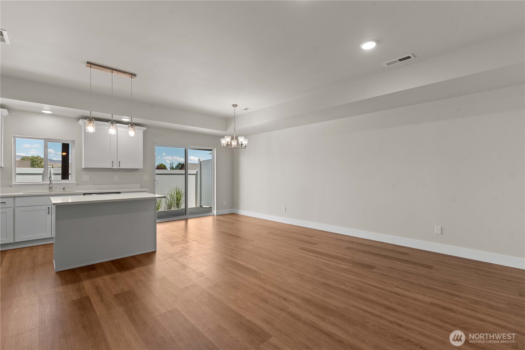 1030 Finch Lane, Unit A3 Wenatchee, WA 98801 - Photo 7 of 24 a large kitchen with a wooden floor and a sink