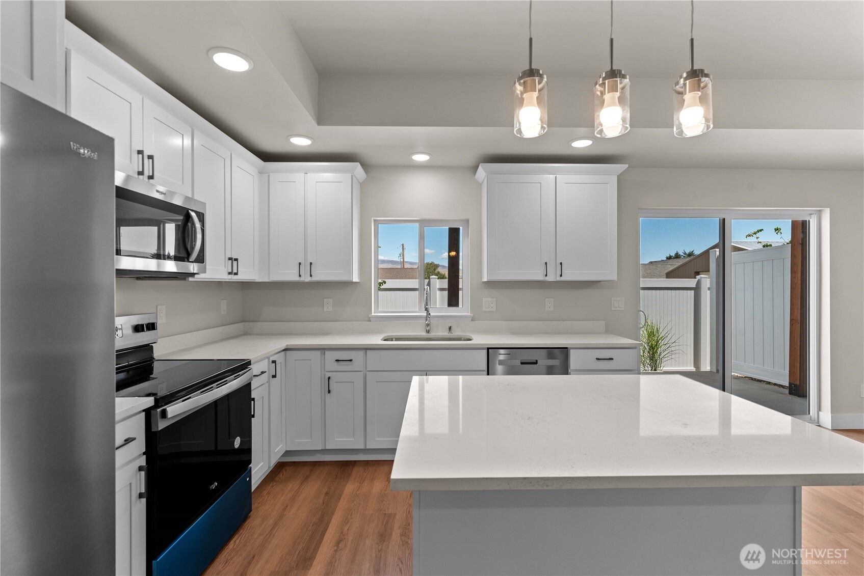 1030 Finch Lane, Unit A3 Wenatchee, WA 98801 - Photo 10 of 24 a kitchen with kitchen island granite countertop stainless steel appliances cabinets a sink and a counter top space