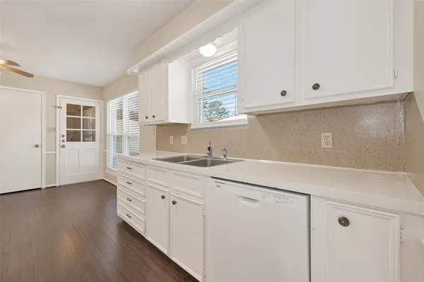 a kitchen with a sink cabinets and window