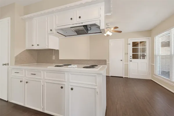a kitchen with cabinets and appliances