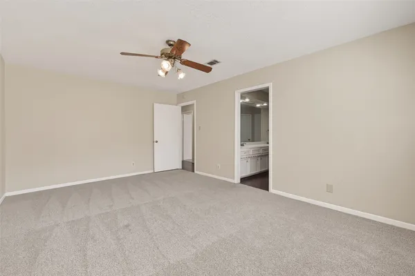 a view of an empty room with a fan