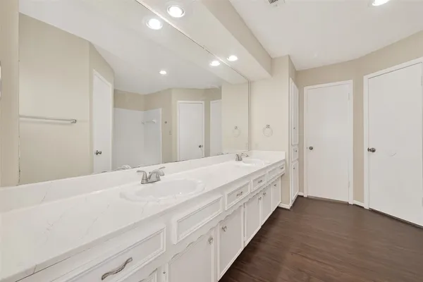 a bathroom with a double vanity sink and a mirror
