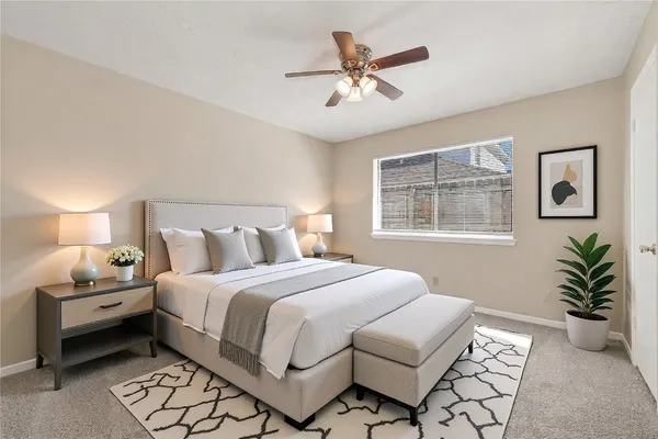 a bedroom with a large bed and a window
