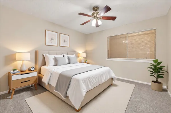 a bedroom with a large bed and a window