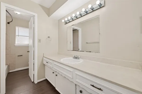 a bathroom with a sink a vanity and a mirror