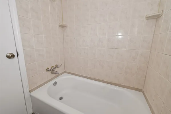 a white bath tub sitting in a bathroom