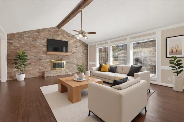 a living room with furniture a fireplace and a flat screen tv