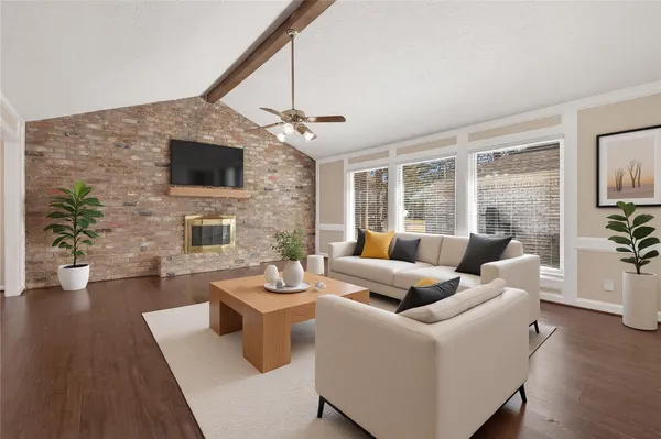 a living room with furniture a fireplace and a flat screen tv